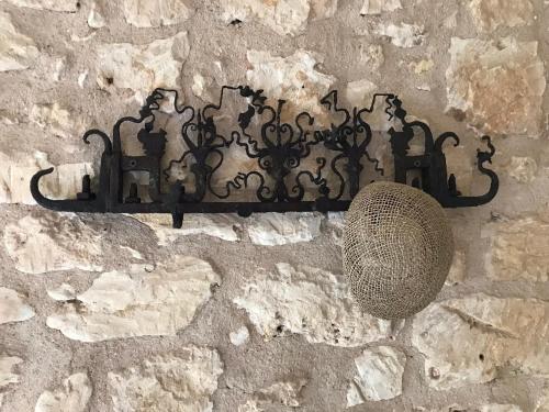 a metal object on the side of a stone wall at Casa Farfaglia in Noto