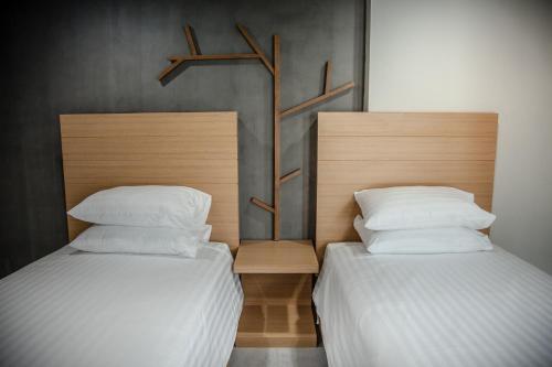 Ένα ή περισσότερα κρεβάτια σε δωμάτιο στο M1 Hotel