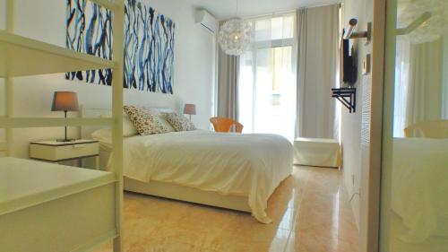 a bedroom with a bed and a large window at R1102ERI by euroresort in Marsalforn