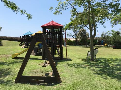 a playground with a slide in a park at Different Atmosphere Suite in Caesarea
