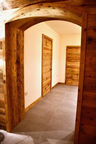 an empty room with wooden walls and doors at Hotel Alpenrose Wellness in Vattaro