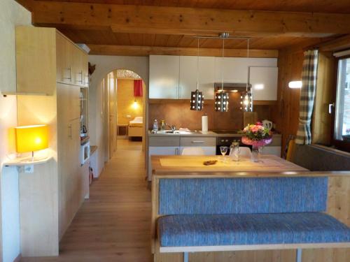 a kitchen with a blue bench in a room at Appartement Anneke in Niedernsill