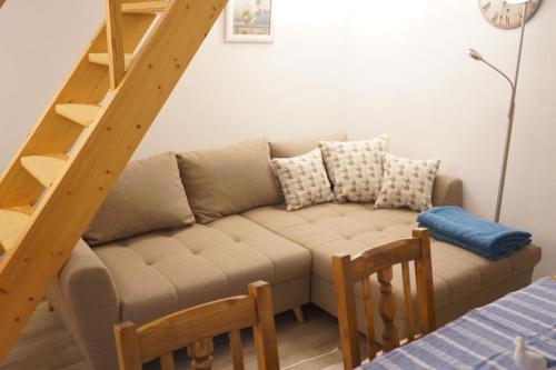 a living room with a couch and a staircase at Fischerhus In Krummin - nur für Urlauber in Krummin