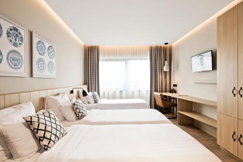 Giường trong phòng chung tại Urban Lodge Hotel