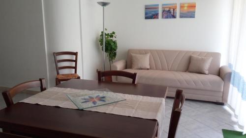 een woonkamer met een tafel en een bank bij Casa Victoria in Golfo Aranci