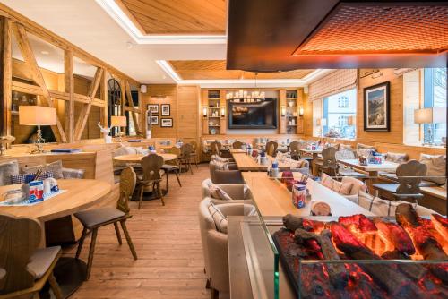 a restaurant with tables and couches and a fireplace at Best Western Plus Hotel Ostertor in Bad Salzuflen