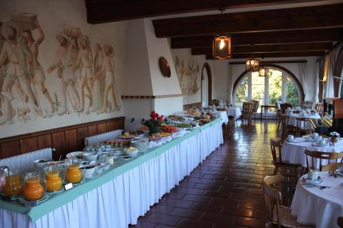 a row of tables in a restaurant with food on them at Hotel Toriba in Campos do Jordão
