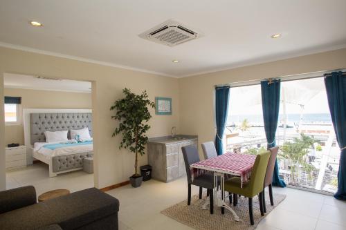 ein Wohnzimmer mit einem Tisch und einem Bett in der Unterkunft Hotel Islander Bonaire in Kralendijk