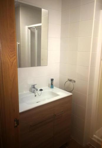 a bathroom with a sink and a mirror at Casa Rural Grajos I in Grajos