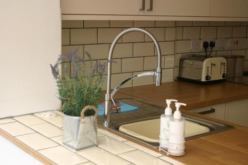 a kitchen sink with a faucet next to a counter at Beach Links in Prestatyn