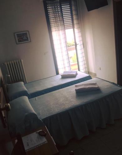 Postel nebo postele na pokoji v ubytování Hotel Cinzia
