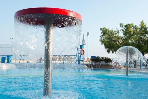a fountain in the middle of a pool of water at Corvino Resort in Monopoli