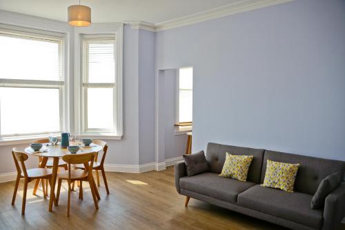 a living room with a couch and a table at Seaview in Worthing