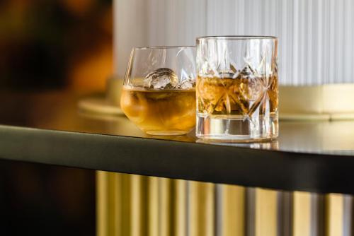 two glasses of whiskey sitting on a table at Hotel Kossak in Kraków