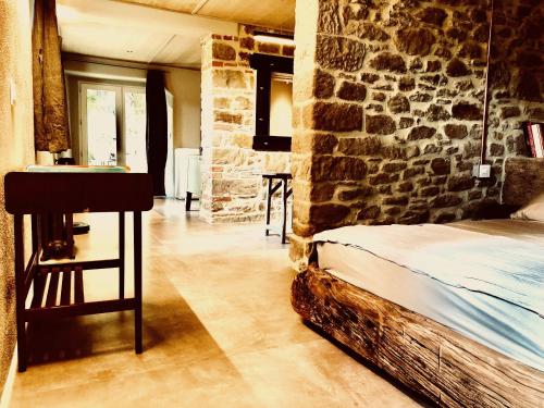 a bedroom with a bed and a stone wall at PIPPO'S LITTLE RESORT/2 in Poppi
