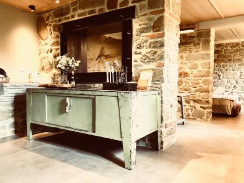 a green cabinet in a room with a stone wall at PIPPO'S LITTLE RESORT/2 in Poppi