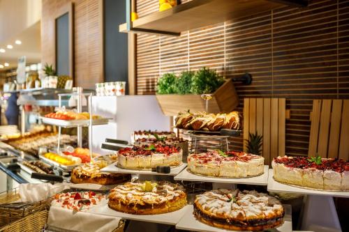 a buffet filled with lots of cakes and other desserts at Valamar Argosy Hotel in Dubrovnik