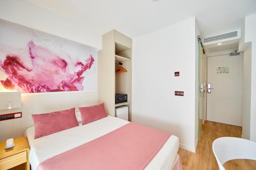 a bedroom with a bed and a painting on the wall at MLL Mediterranean Bay - Adults Only in El Arenal