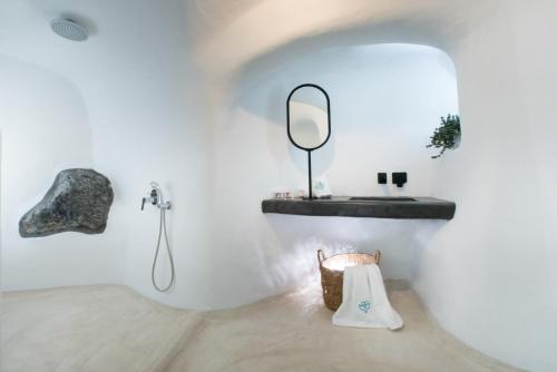 a bathroom with a mirror and a sink at Sophia Finikia Villas in Oia