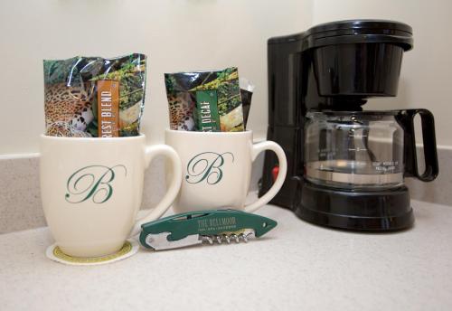 two coffee cups on a counter next to a coffee maker at The Bellmoor Inn and Spa in Rehoboth Beach