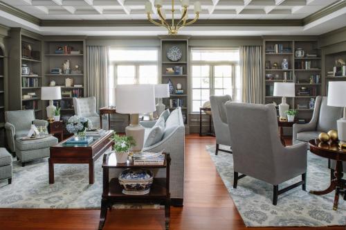 a living room with chairs and tables and a chandelier at The Bellmoor Inn and Spa in Rehoboth Beach