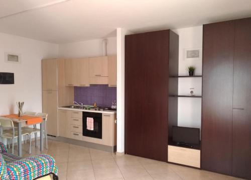 a living room with a kitchen and a table at Residence Ilario Suite Hotel in Riccione
