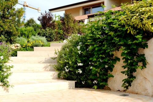 a set of stairs in front of a house with flowers at A CASA DA LISA (exclusive room) in Turi