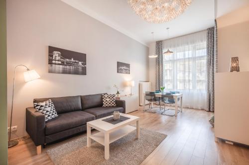 a living room with a couch and a table at Synagogue Apartment Dohány in Budapest