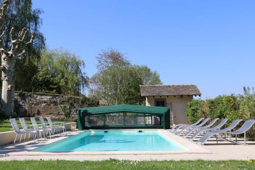 a group of chairs and a swimming pool at Chambres et table L' échappée in Bouvesse-Quirieu