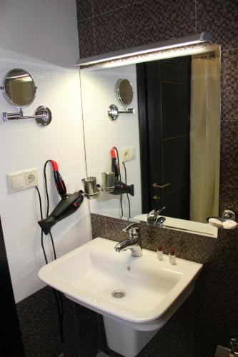 a bathroom with a sink and a mirror at Hotel Villa Palace in Bakuriani