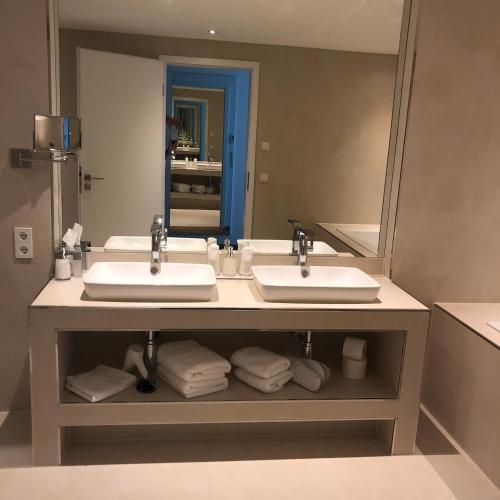 a bathroom with two sinks and a large mirror at Voss Villa in Leipzig