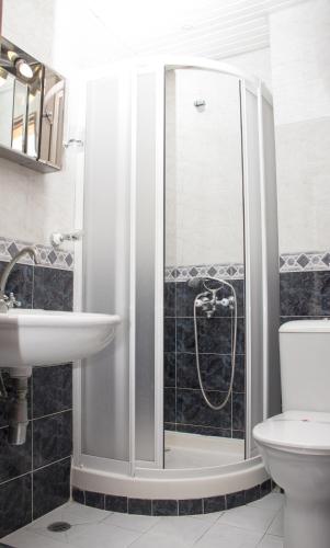 a bathroom with a shower and a sink at Apartment Pier in Varna City