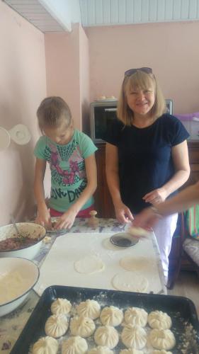 a woman and a child making cookies in a kitchen at Apartments on Akhalubani St 2 in Tbilisi City