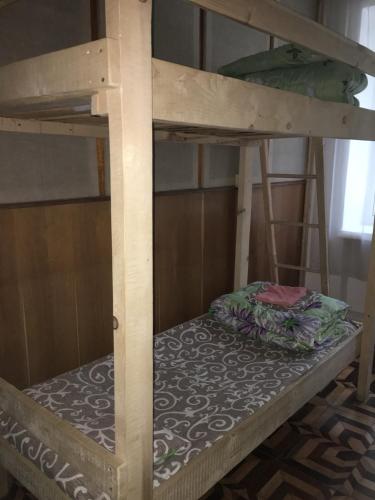 a bunk bed with a pillow on the bottom bunk at Baron Munchausen Guest House in Kamianets-Podilskyi