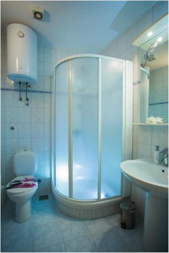 a bathroom with a shower and a toilet and a sink at Apartments Maja in Podstrana