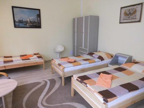 a room with two beds and a table at Maryla in Kołobrzeg