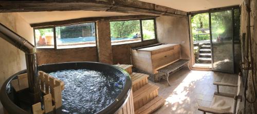 a large bathroom with a tub filled with water at La Cannara in Marta