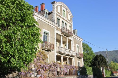 a large house with purple wreaths on it at Chateau de La Lanette in Saléchan