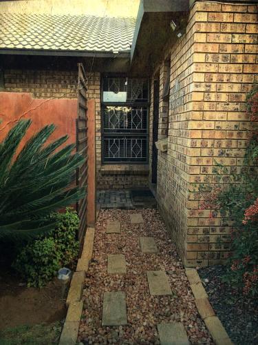a walkway leading to a door in a brick building at Revenir in Middelburg