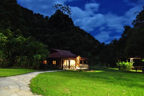 a house in the middle of a grassy field at Platon Ecolodge in Santa Cruz de Barahona