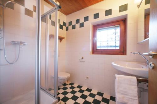 a bathroom with a shower and a sink and a toilet at Chalet an der Schmittenhöhe in Zell am See