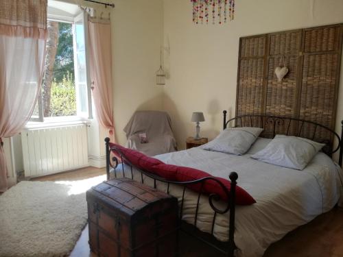 une chambre avec un lit et une grande fenêtre dans l'établissement Mon Petit Soulié, à Loupia