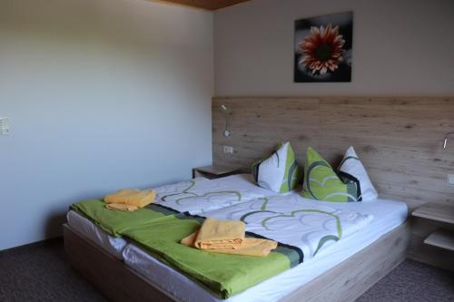 a bedroom with a large bed with a wooden headboard at Pension Hubertushof Monteurunterkunft in Freiberg