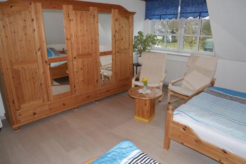 a bedroom with a bed and a table and chairs at Haus Karen in Schafflund