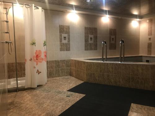 a bathroom with two sinks and a shower at Alpari in Irkutsk