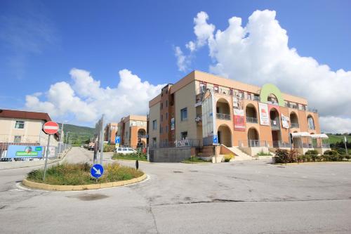 a building with a street sign in front of it at I Rocchi Hotel in Tito