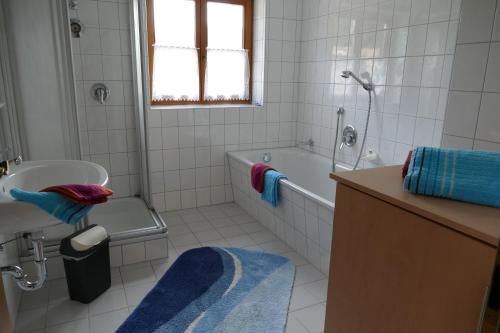 a bathroom with a tub and a toilet and a sink at Haus Wiesenruh in Oberstdorf