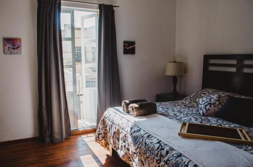 a bedroom with a bed with a laptop on it at Casa Mariel in San Luis Potosí