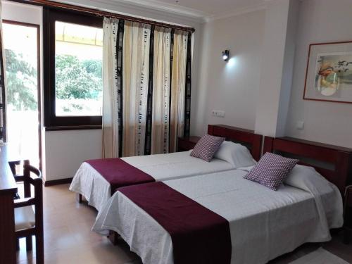 Ένα ή περισσότερα κρεβάτια σε δωμάτιο στο Hotel Balaia Mar
