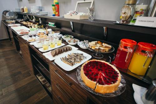 a buffet line with various food items on a table at Hotel Villa Milas in Mostar